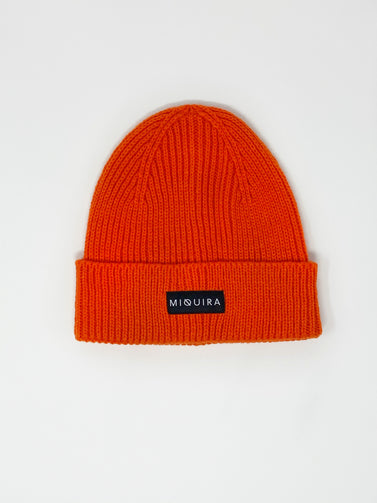 Scarlet acrylic knitted beanie with black Miquira label stitched on the outside.