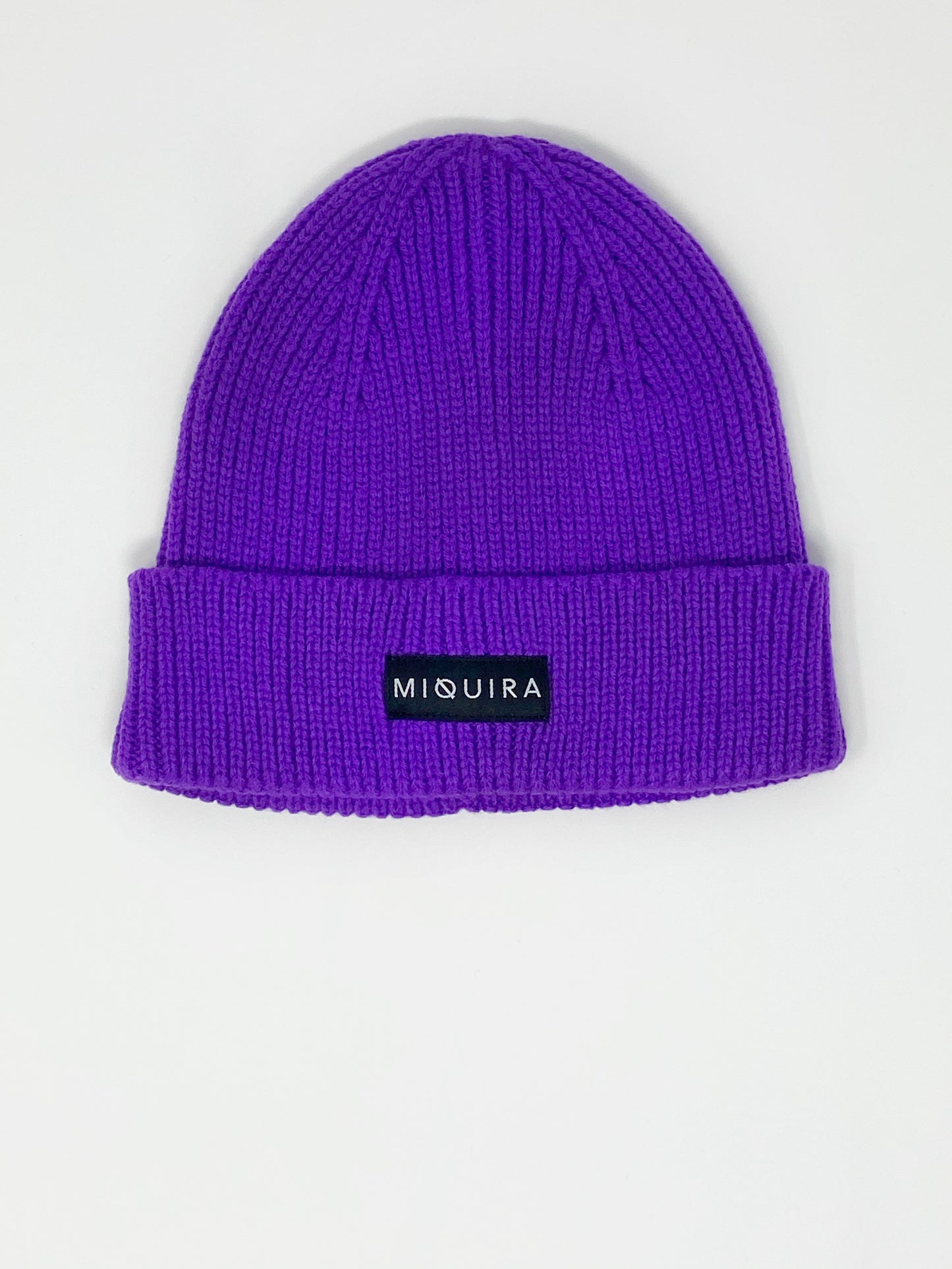 Violet acrylic knitted beanie with black Miquira label stitched on the outside.