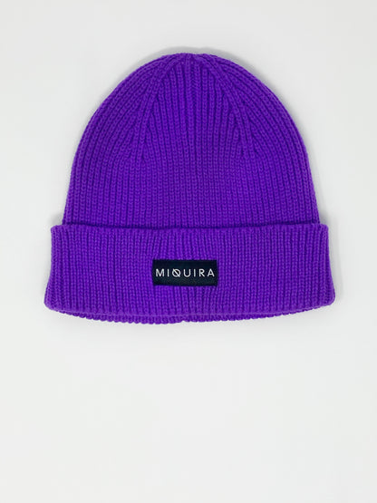 Violet acrylic knitted beanie with black Miquira label stitched on the outside.